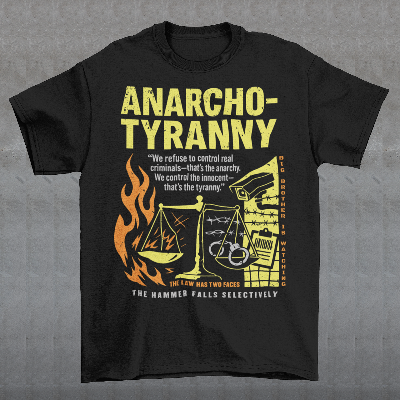 Black t-shirt featuring a distressed yellow “ANARCHO-TYRANNY” graphic with scales of justice, flames, barbed wire, surveillance imagery, and prison-themed artwork. The design includes the phrases “THE LAW HAS TWO FACES” and “THE HAMMER FALLS SELECTIVELY,” creating a bold political statement focused on authority, government power, civil liberties, and anti-authoritarian themes.