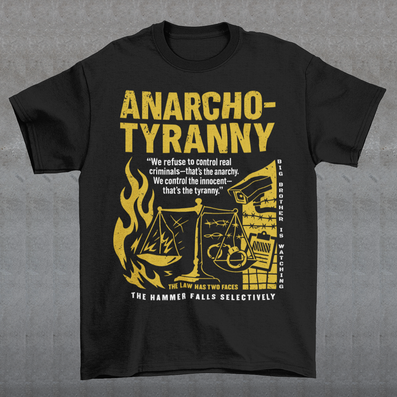 Black t-shirt featuring a distressed yellow “ANARCHO-TYRANNY” graphic with scales of justice, flames, barbed wire, surveillance imagery, and prison-themed artwork. The design includes the phrases “THE LAW HAS TWO FACES” and “THE HAMMER FALLS SELECTIVELY,” creating a bold political statement focused on authority, government power, civil liberties, and anti-authoritarian themes.