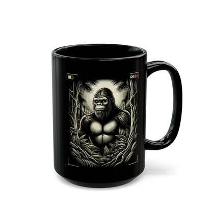 Black mug of Bigfoot being recorded looking through the trees.