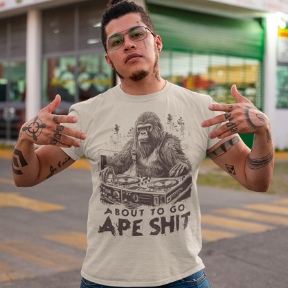 This t-shirt features a bold and eye-catching design of a gorilla playing turntables, surrounded by trees. The gorilla's intense expression and skilled DJing skills convey a sense of energy and excitement. The text "ABOUT TO GO Ape Shit" adds to the playful and humorous tone of the shirt, hinting at the wild and uninhibited fun that the wearer is ready to unleash. This phrase, combined with the gorilla DJ graphic, makes for a unique and memorable design that is sure to stand out in any crowd.