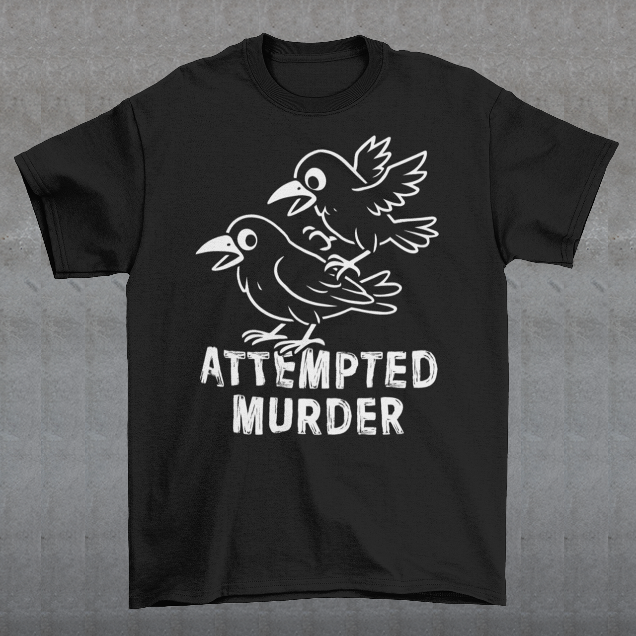 Serve up a little dark humor with a wink and a caw in this “Attempted Murder” t-shirt, a clever play on the classic term for a group of crows. Featuring two mischievous cartoon crows mid-chaos, this design turns a slightly sinister phrase into something irresistibly funny. It’s the kind of joke that lands somewhere between clever wordplay and delightfully inappropriate humor, perfect for those who enjoy their laughs with a shadowy twist.