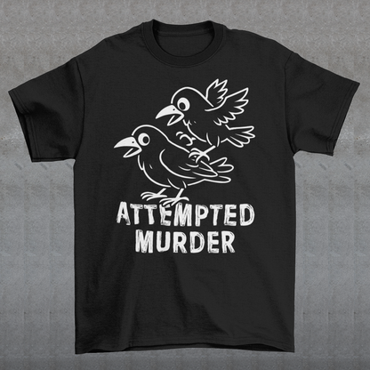 Serve up a little dark humor with a wink and a caw in this “Attempted Murder” t-shirt, a clever play on the classic term for a group of crows. Featuring two mischievous cartoon crows mid-chaos, this design turns a slightly sinister phrase into something irresistibly funny. It’s the kind of joke that lands somewhere between clever wordplay and delightfully inappropriate humor, perfect for those who enjoy their laughs with a shadowy twist.