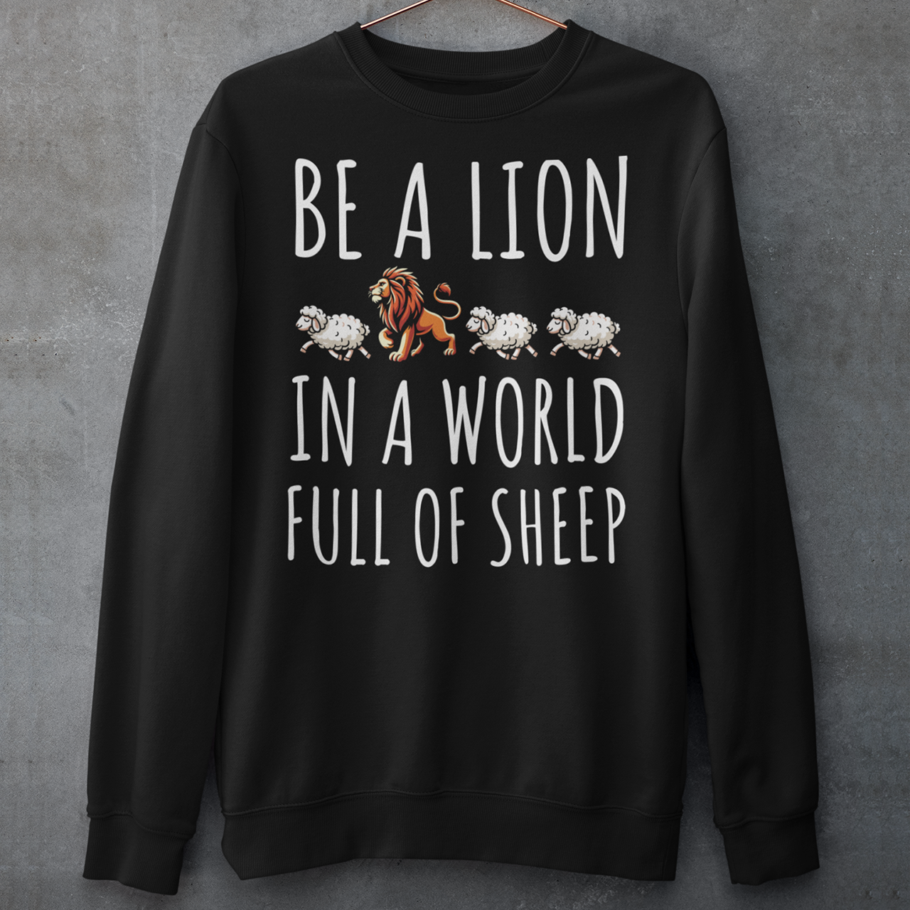 Black sweatshirt with a lion and three sheep and text BE A LION IN A WORLD FULL OF SHEEP.