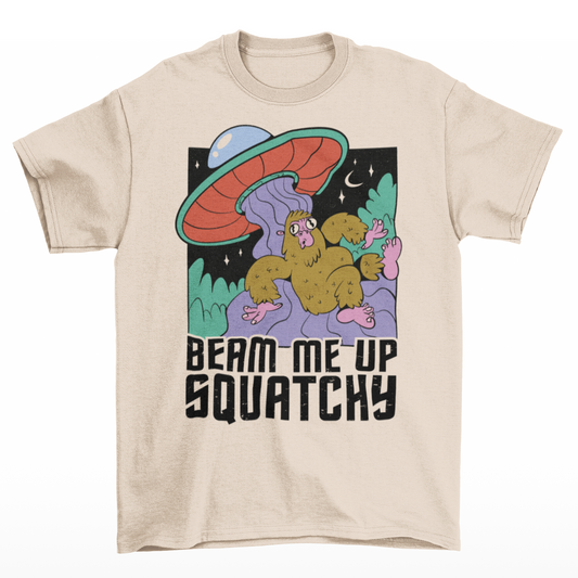 Cream t-shirt featuring a Sasquatch being abducted by a UFO with text "BEAM ME UP SQUATCHY".