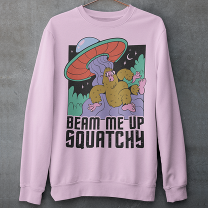 Introducing the extraterrestrial enigma that'll spark conversations and laughter wherever you go – the "BEAM ME UP SQUATCHY" sweatshirt. This whimsical masterpiece seamlessly blends the worlds of cryptozoology and outer space, leaving a trail of intrigue and smiles in its wake. Set against a backdrop of midnight sky, this sweatshirt showcases a captivating scene that defies conventional explanation.