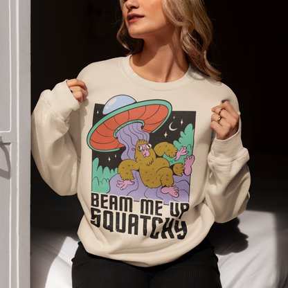 Introducing the extraterrestrial enigma that'll spark conversations and laughter wherever you go – the "BEAM ME UP SQUATCHY" sweatshirt. This whimsical masterpiece seamlessly blends the worlds of cryptozoology and outer space, leaving a trail of intrigue and smiles in its wake. Set against a backdrop of midnight sky, this sweatshirt showcases a captivating scene that defies conventional explanation.