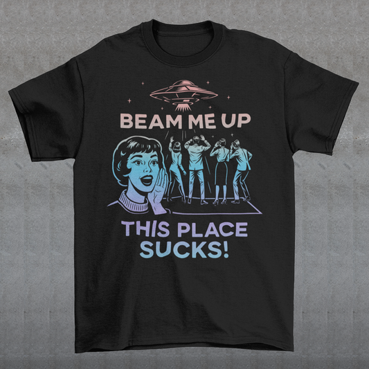 This snark-powered retro UFO t-shirt brings the perfect escape fantasy to life. A vintage-style flying saucer hovers above a crowd while a wide-eyed woman rallies for interstellar rescue, paired with the bold line “Beam Me Up, This Place Sucks!” The design has a classic pulp-sci-fi look that feels like it tumbled out of an old comic rack. Ideal for anyone who survives their days with eye rolls, cosmic daydreams, and a desire to be anywhere else in the galaxy.