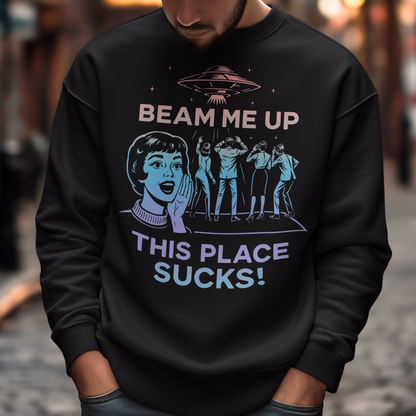 This snark-powered retro UFO sweatshirt brings the perfect escape fantasy to life. A vintage-style flying saucer hovers above a crowd while a wide-eyed woman rallies for interstellar rescue, paired with the bold line “Beam Me Up, This Place Sucks!” The design has a classic pulp-sci-fi look that feels like it tumbled out of an old comic rack. Ideal for anyone who survives their days with eye rolls, cosmic daydreams, and a desire to be anywhere else in the galaxy.