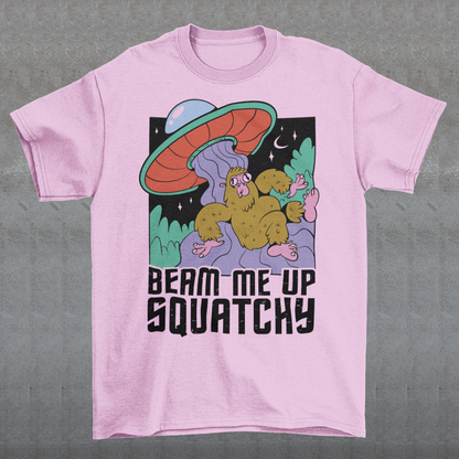 Introducing the extraterrestrial enigma that'll spark conversations and laughter wherever you go – the "BEAM ME UP SQUATCHY" t-shirt. This whimsical masterpiece seamlessly blends the worlds of cryptozoology and outer space, leaving a trail of intrigue and smiles in its wake. Set against a backdrop of midnight sky, this t-shirt showcases a captivating scene that defies conventional explanation.