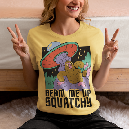 Introducing the extraterrestrial enigma that'll spark conversations and laughter wherever you go – the "BEAM ME UP SQUATCHY" t-shirt. This whimsical masterpiece seamlessly blends the worlds of cryptozoology and outer space, leaving a trail of intrigue and smiles in its wake. Set against a backdrop of midnight sky, this t-shirt showcases a captivating scene that defies conventional explanation.