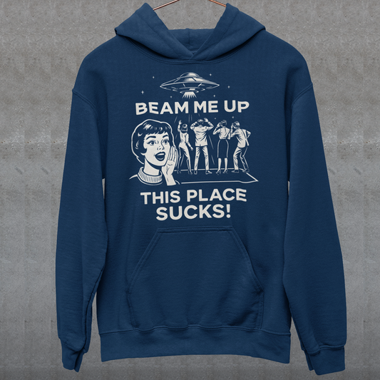 This snark-powered retro UFO hoodie brings the perfect escape fantasy to life. A vintage-style flying saucer hovers above a crowd while a wide-eyed woman rallies for interstellar rescue, paired with the bold line “Beam Me Up, This Place Sucks!” The design has a classic pulp-sci-fi look that feels like it tumbled out of an old comic rack. Ideal for anyone who survives their days with eye rolls, cosmic daydreams, and a desire to be anywhere else in the galaxy.