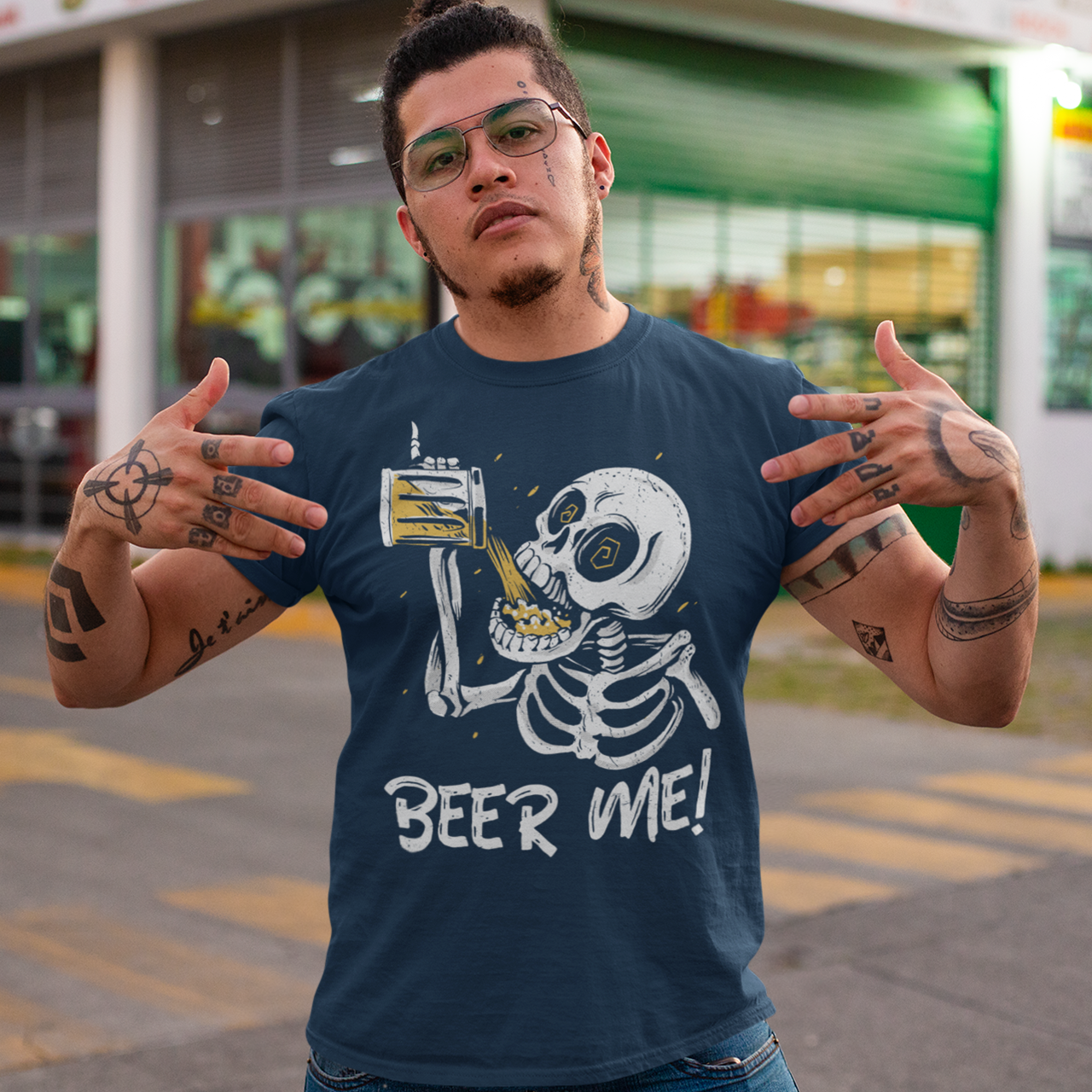 Navy t-shirt of a skeleton drinking a beer with text underneath "BEER ME!"