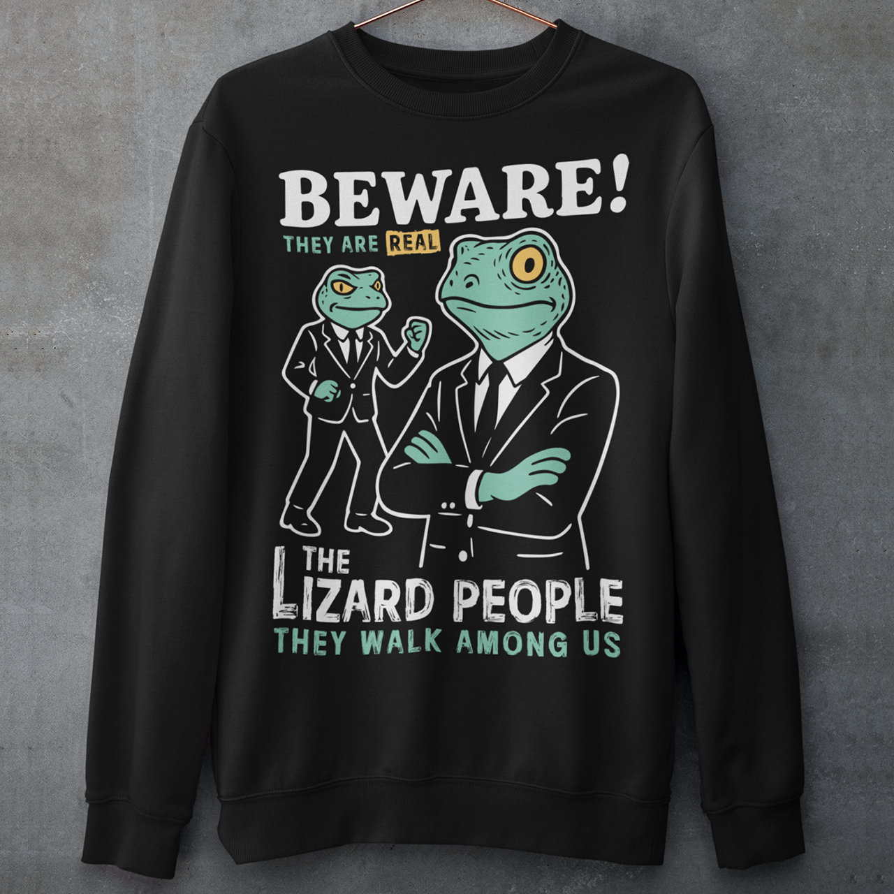 This “Beware! Lizard People” sweatshirt turns a classic conspiracy wink into wearable humor. The suited-up reptilian characters strike a bold, comic-book stance that adds a playful sense of intrigue to your outfit. Crisp line art and a vintage poster feel make it a standout for sci-fi lovers, meme collectors, and anyone who enjoys a touch of tongue-in-cheek absurdity. It’s the perfect shirt for sparking conversations and raising eyebrows in all the right ways.