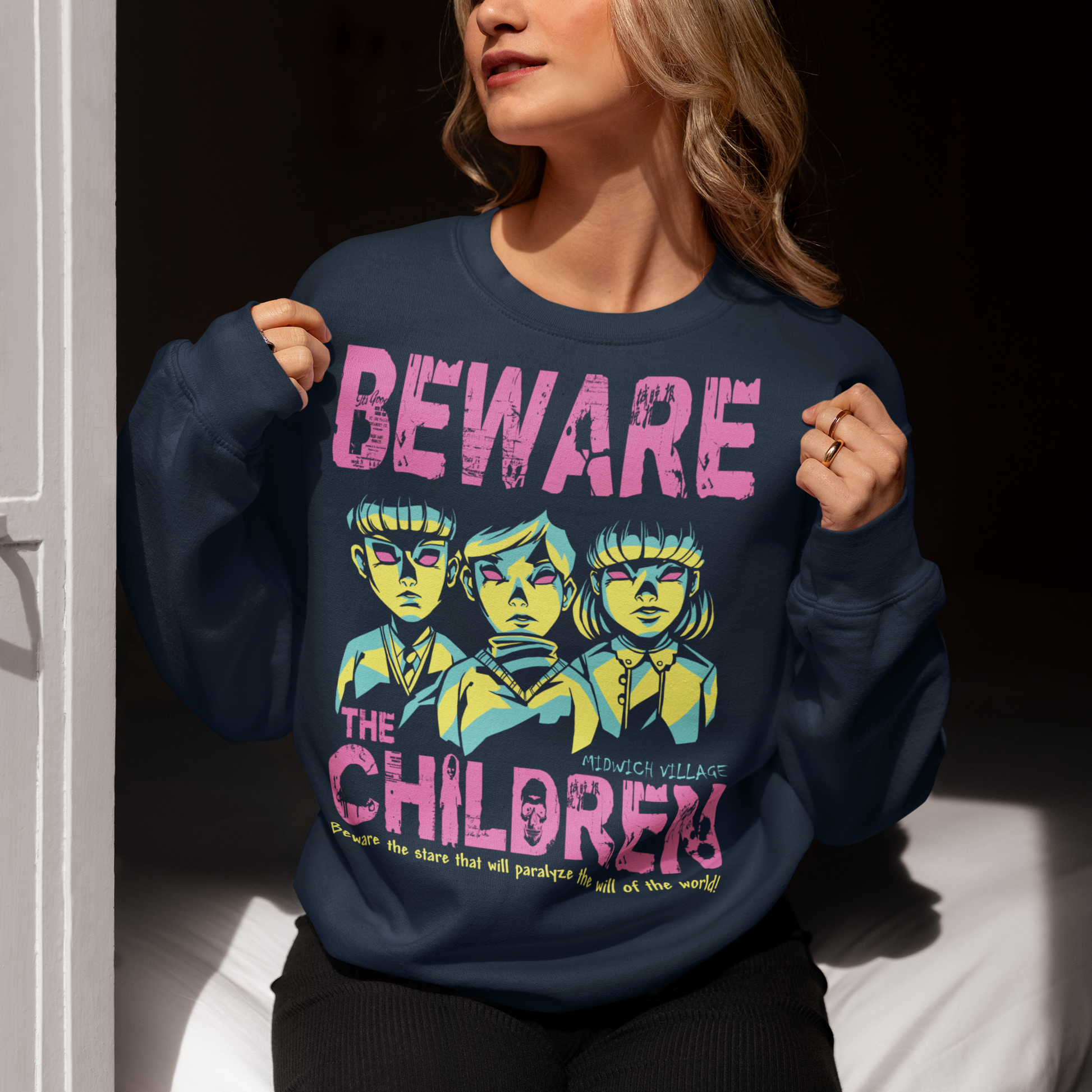 Navy sweatshirt of telepathic kids from the Midwich Cuckoos and text "BEWARE THE CHILDREN."