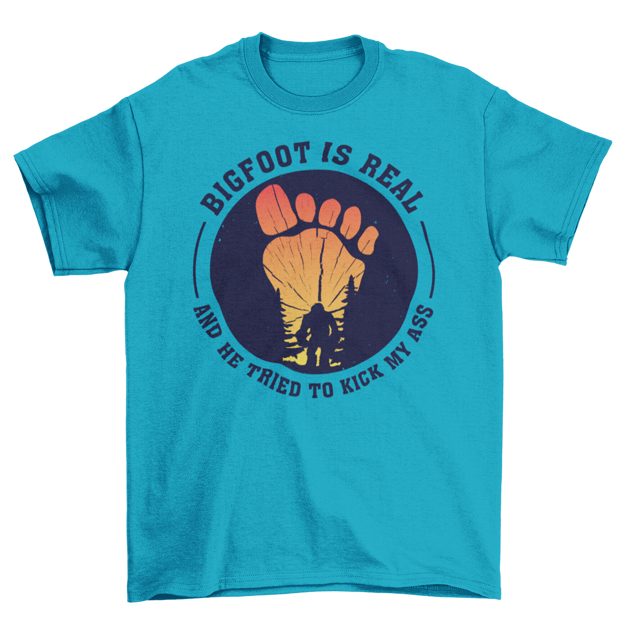 Aqua t-shirt with a bigfoot silhouette on a sunset foot with text "BIGFOOT IS REAL AND HE TRIED TO KICK MY ASS".