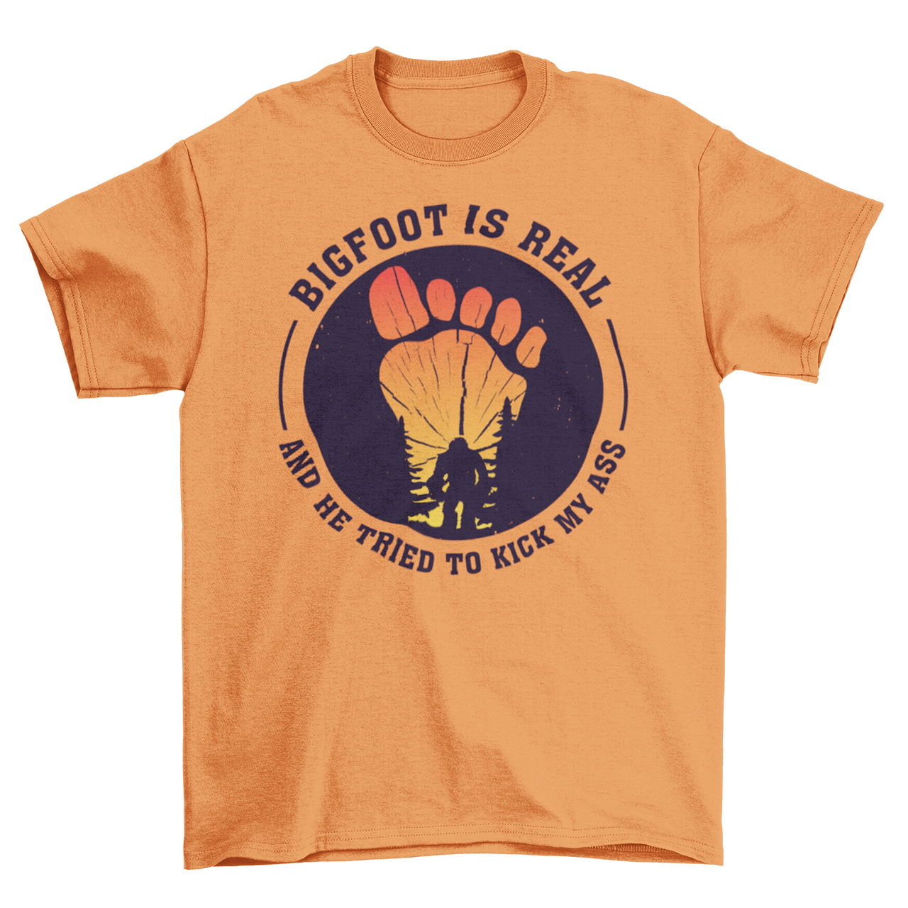 Orange t-shirt with a bigfoot silhouette on a sunset foot with text "BIGFOOT IS REAL AND HE TRIED TO KICK MY ASS".