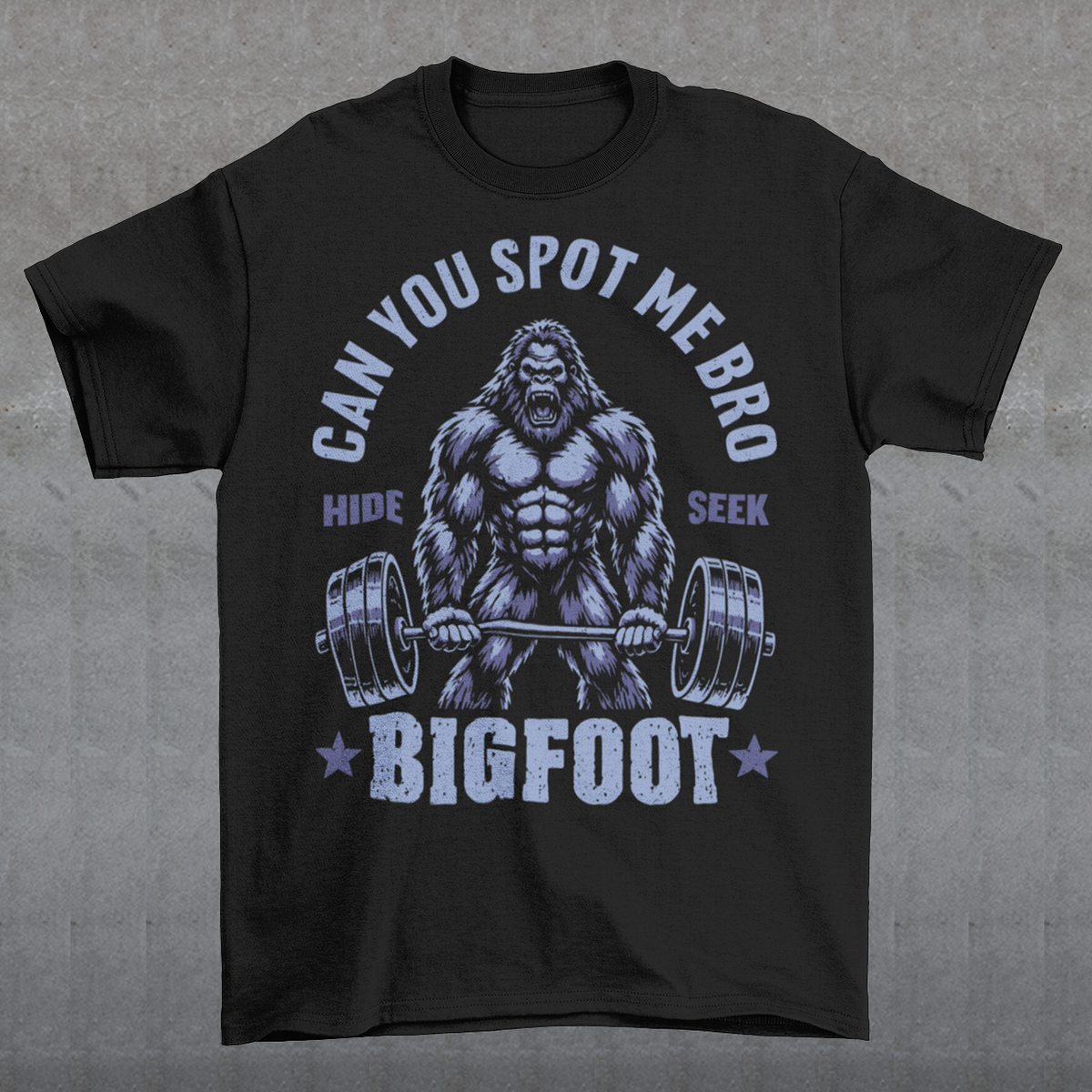 Black T-shirt featuring a muscular cartoon Bigfoot lifting a heavily loaded barbell. The graphic has bold white vintage-style lettering reading “CAN YOU SPOT ME BRO” above the Sasquatch, with “HIDE” and “SEEK” on either side and “BIGFOOT” beneath the weightlifter, flanked by stars. The design combines Bigfoot humor, gym culture, weightlifting, and cryptid themes.