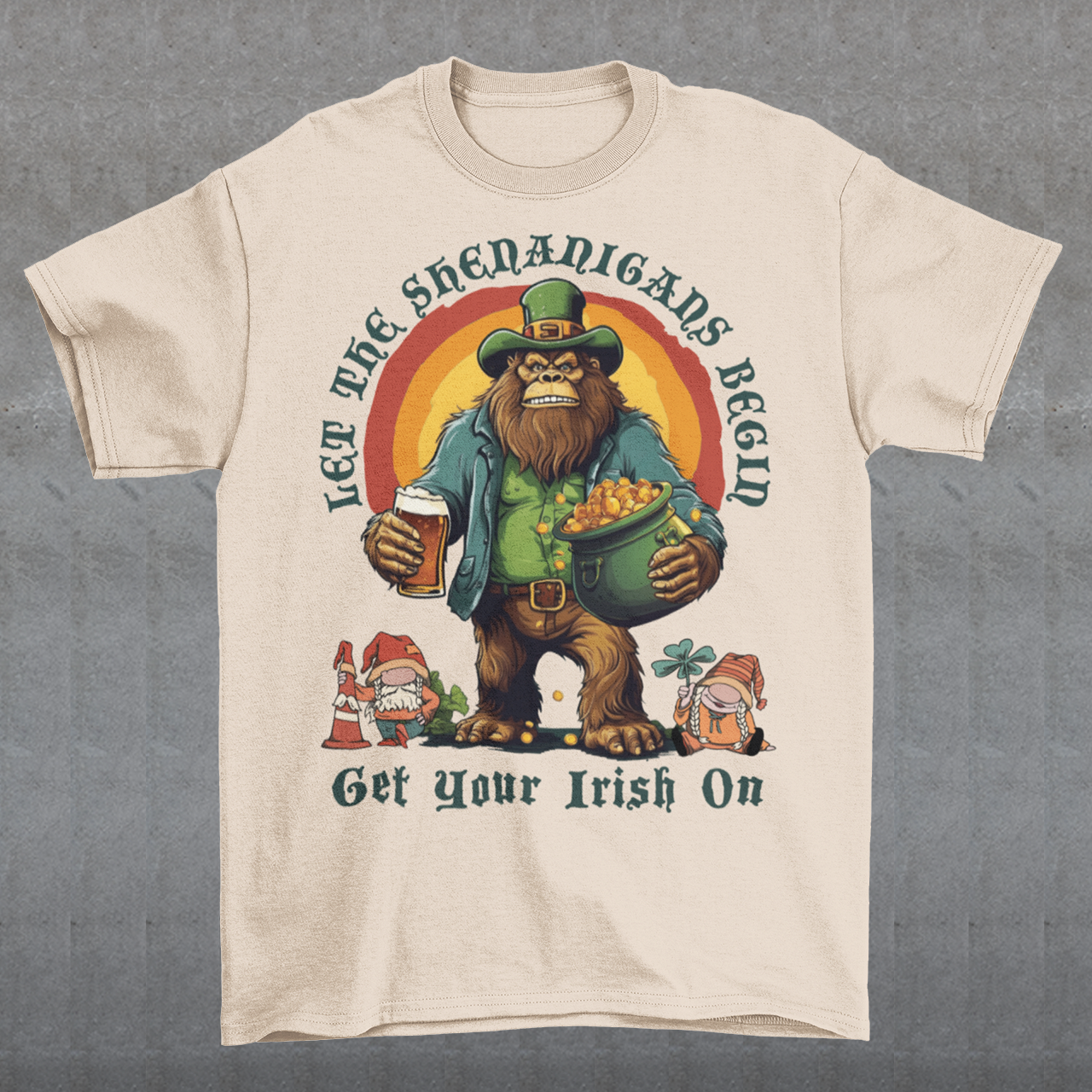 Get ready to celebrate St. Patrick's Day in style with our hilarious and festive Bigfoot-themed t-shirt! This shirt features everyone's favorite cryptid, Bigfoot, dressed in full leprechaun attire, complete with a green hat and shamrock-adorned vest. Bigfoot is depicted holding a frothy beer in one hand and a gleaming pot of gold in the other, ready to join in the festivities. Above this whimsical scene, bold text declares, "LET THE SHENANIGANS BEGIN."