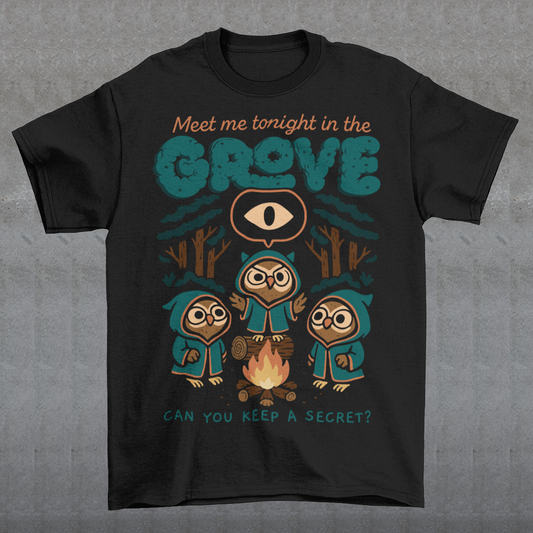 Black t-shirt featuring three hooded owl characters gathered around a campfire in a dark forest. Above them is the text “Meet Me Tonight in the Grove” with an all-seeing eye symbol, and below reads “Can You Keep a Secret?” The design uses teal, orange, and cream tones in a spooky vintage cartoon style inspired by occult themes and secret societies.