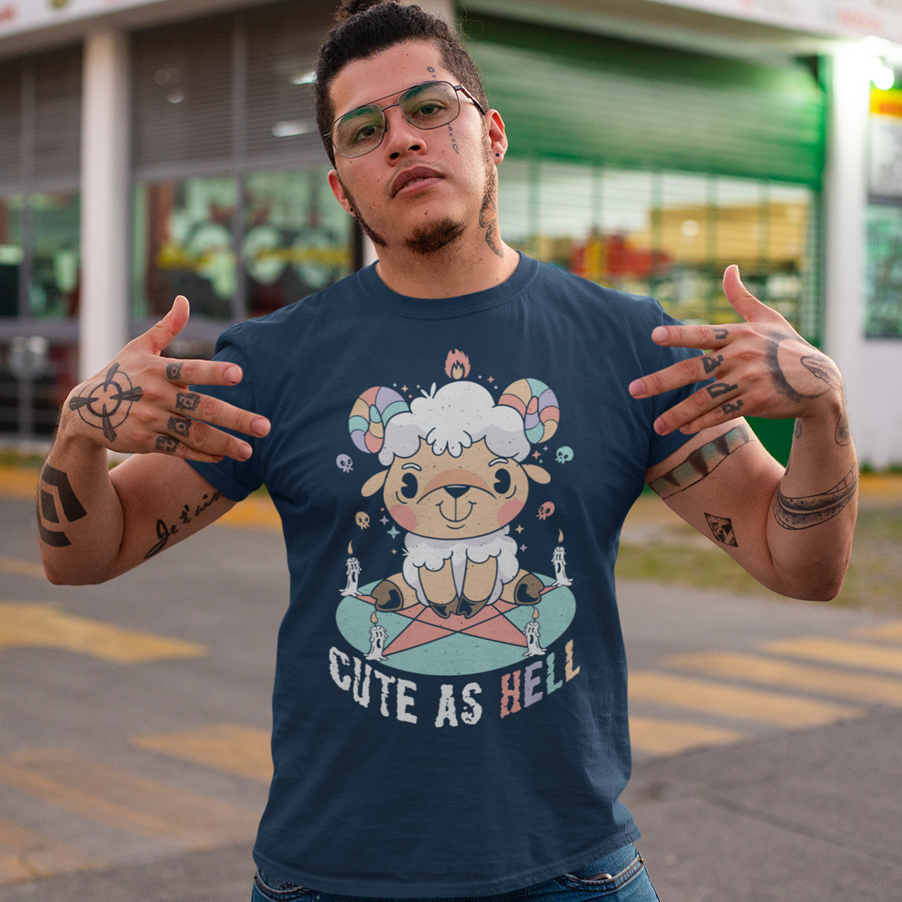 Navy t-shirt with a cute goat sitting on a pentagram with text "CUTE AS HELL".