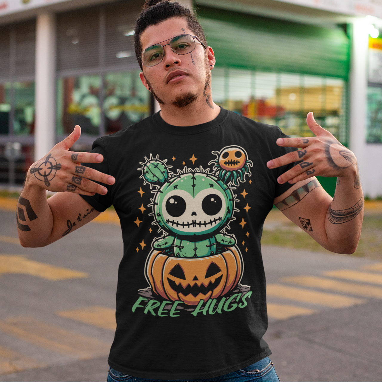 Black Halloween t-shirt of a cactus teddy in a pumpkin with text underneath "FREE HUGS."