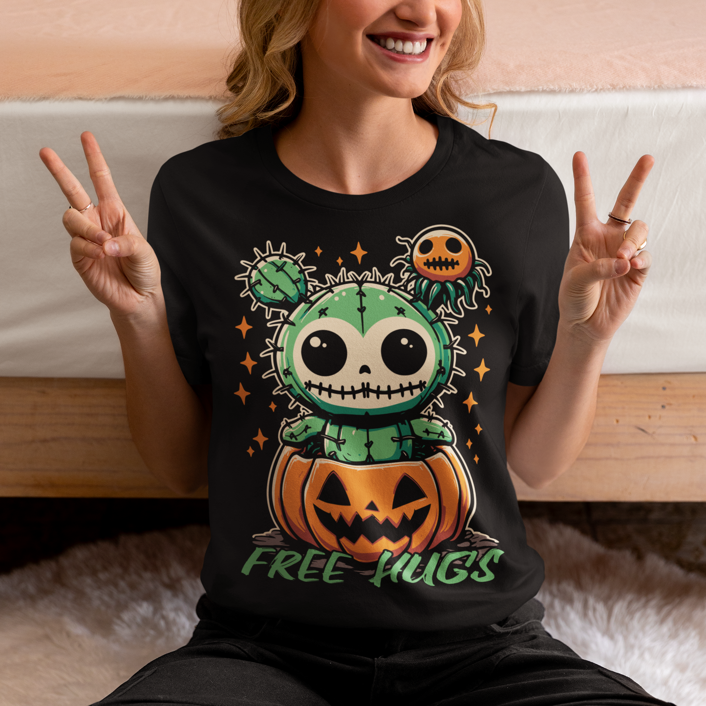 Black Halloween t-shirt of a cactus teddy in a pumpkin with text underneath "FREE HUGS."