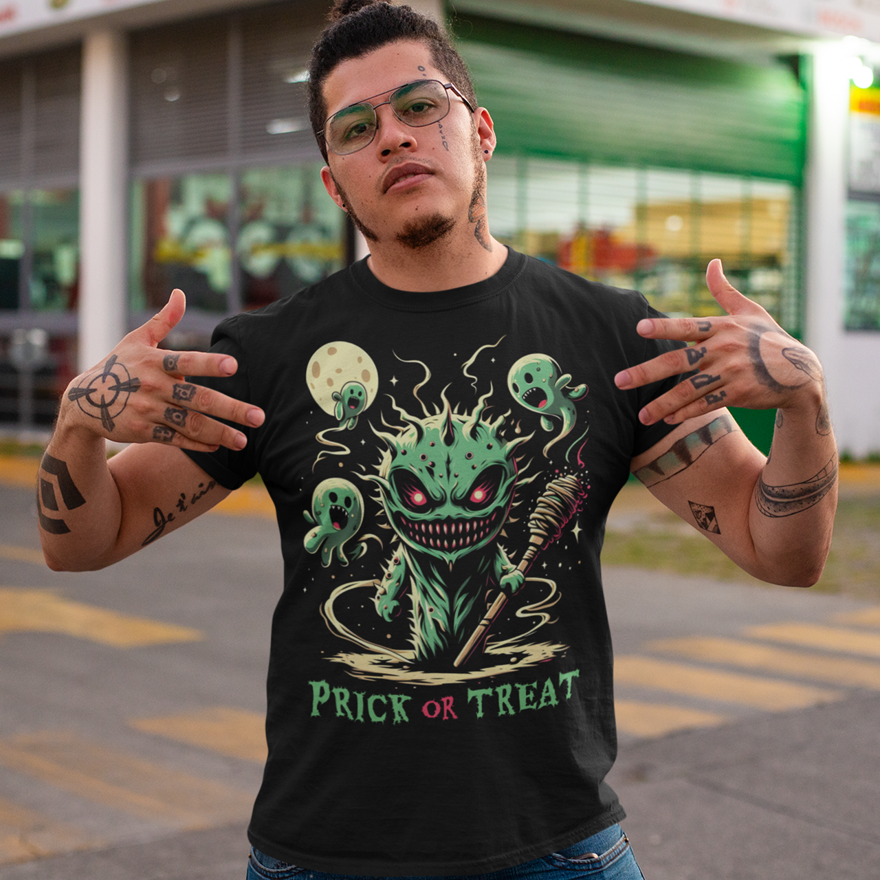 Black Halloween t-shirt of a scary cactus with cactus ghosts with text underneath "PRICK OR TREAT".