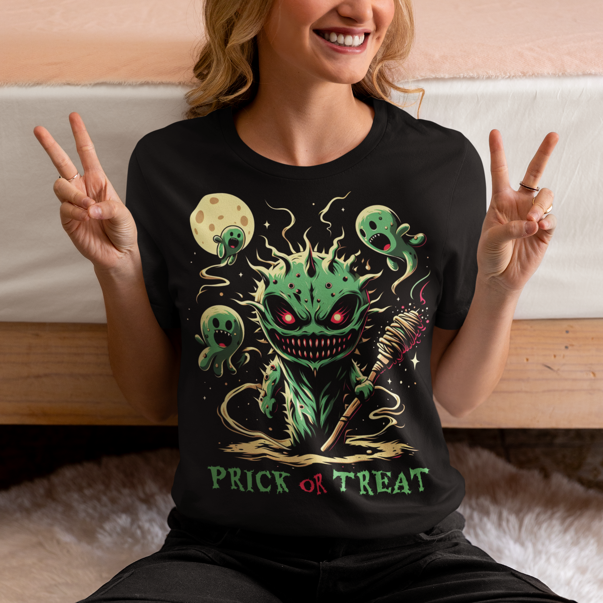 Black Halloween t-shirt of a scary cactus with cactus ghosts with text underneath "PRICK OR TREAT".