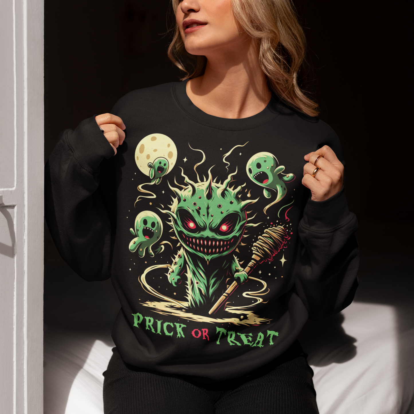 Black Halloween sweatshirt of a scary cactus with cactus ghosts with text underneath "PRICK OR TREAT".