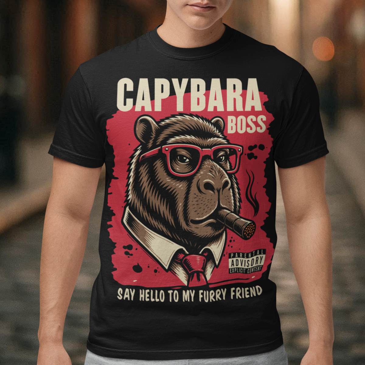 Black t-shirt featuring a bold vintage-style capybara graphic wearing red sunglasses, a suit and tie, and smoking a cigar. The design includes “CAPYBARA BOSS” text, a red background, and the phrase “SAY HELLO TO MY FURRY FRIEND,” creating a funny gangster-inspired animal design for capybara lovers and meme fans.