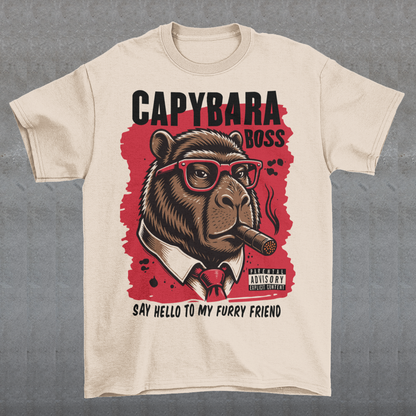 Beige t-shirt featuring a bold vintage-style capybara graphic wearing red sunglasses, a suit and tie, and smoking a cigar. The design includes “CAPYBARA BOSS” text, a red background, and the phrase “SAY HELLO TO MY FURRY FRIEND,” creating a funny gangster-inspired animal design for capybara lovers and meme fans.
