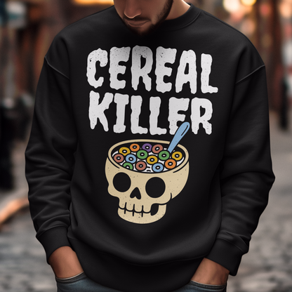 Black sweatshirt featuring the phrase “Cereal Killer” in large distressed white letters above a cartoon skull used as a cereal bowl filled with colorful cereal loops and a spoon. Funny dark humor design combining spooky Halloween style with breakfast pun humor.