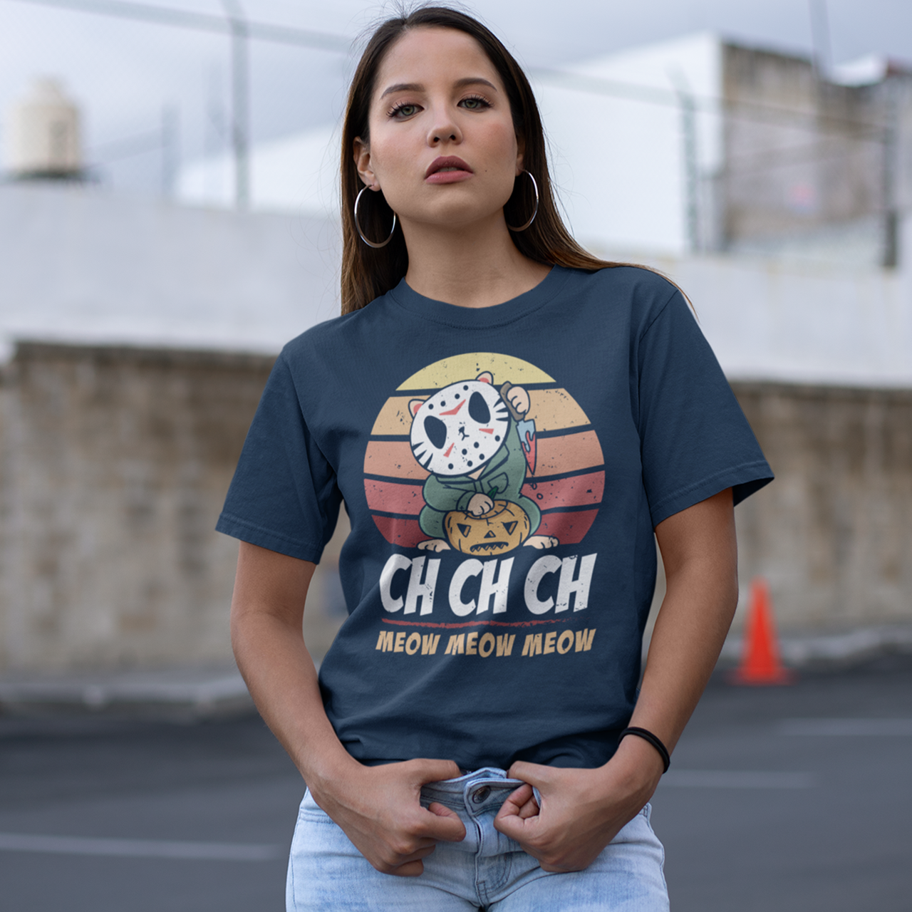 Navy halloween t-shirt of a cat in a horror costume with retro sun background with text underneath  "CH CH CH MEOW MEOW MEOW".