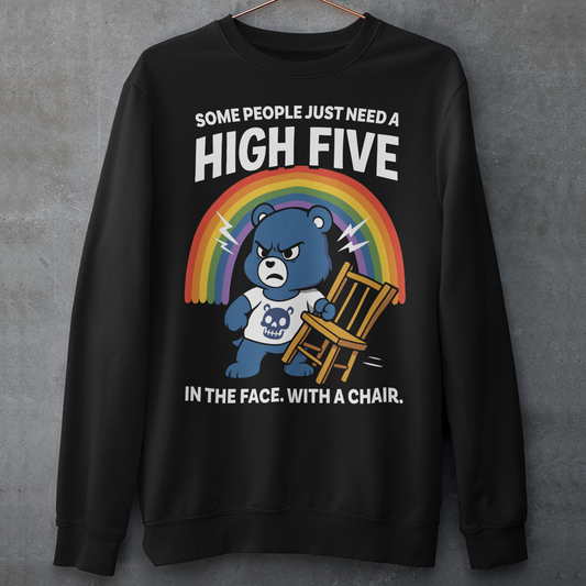 CHAIR BEAR HIGH FIVE SWEATSHIRT. Sweet meets savage in this hilariously bold “High Five” Bear shirt. At first glance, it’s all rainbows and retro cartoon charm, but look a little closer and you’ll catch the punchline. Featuring a grumpy blue bear under a bright rainbow, gripping a chair with questionable intentions, this design flips cute nostalgia into edgy humor with a perfectly timed twist.
