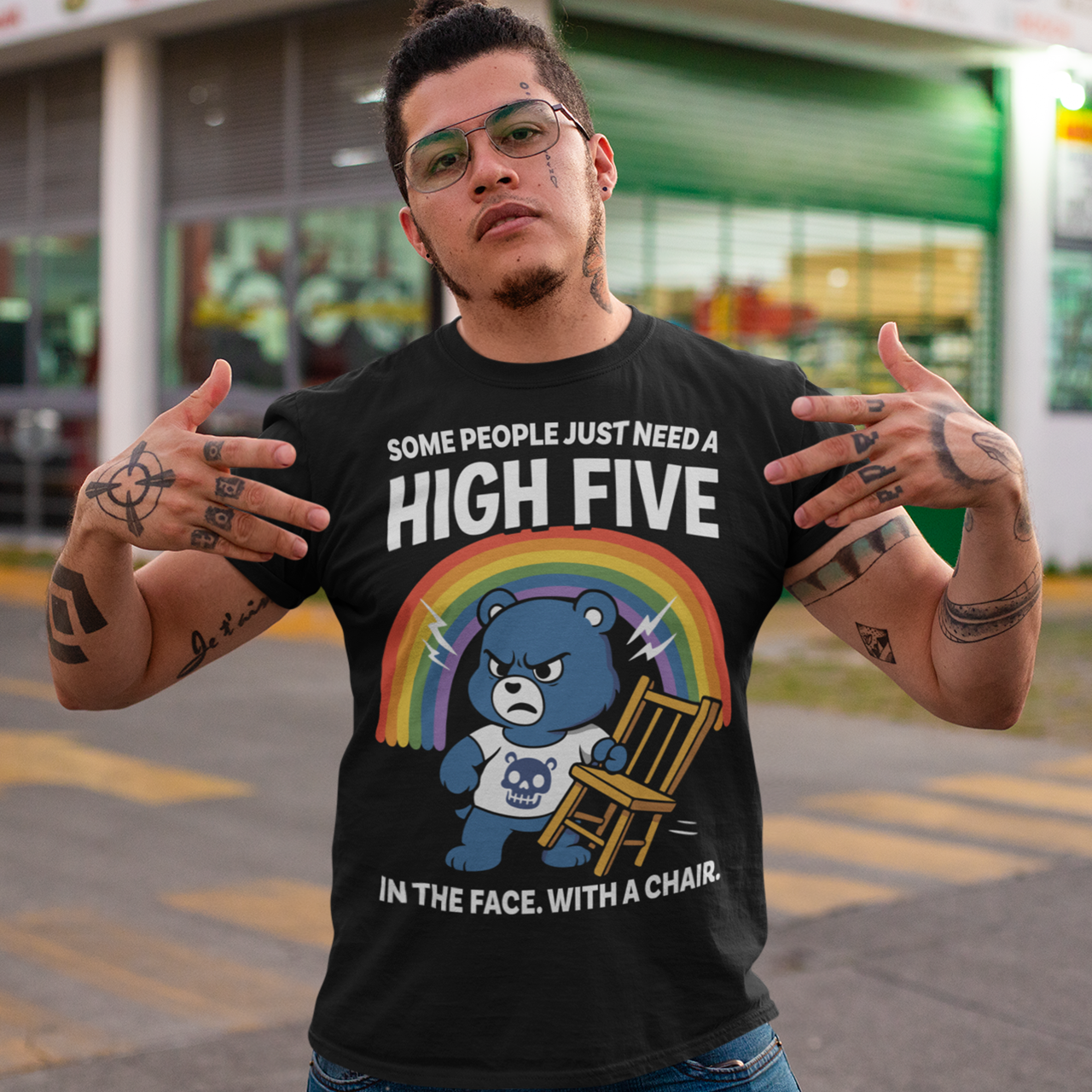 CHAIR BEAR SKULL HIGH FIVE T-SHIRT. Sweet meets savage in this hilariously bold “High Five” Bear t-shirt. At first glance, it’s all rainbows and retro cartoon charm, but look a little closer and you’ll catch the punchline. Featuring a grumpy blue bear under a bright rainbow, gripping a chair with questionable intentions, this design flips cute nostalgia into edgy humor with a perfectly timed twist.