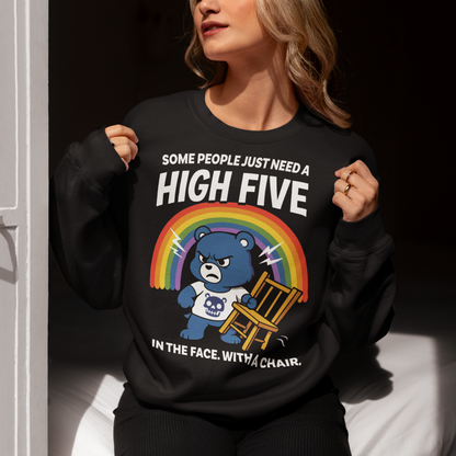CHAIR BEAR HIGH FIVE SWEATSHIRT. Sweet meets savage in this hilariously bold “High Five” Bear shirt. At first glance, it’s all rainbows and retro cartoon charm, but look a little closer and you’ll catch the punchline. Featuring a grumpy blue bear under a bright rainbow, gripping a chair with questionable intentions, this design flips cute nostalgia into edgy humor with a perfectly timed twist.