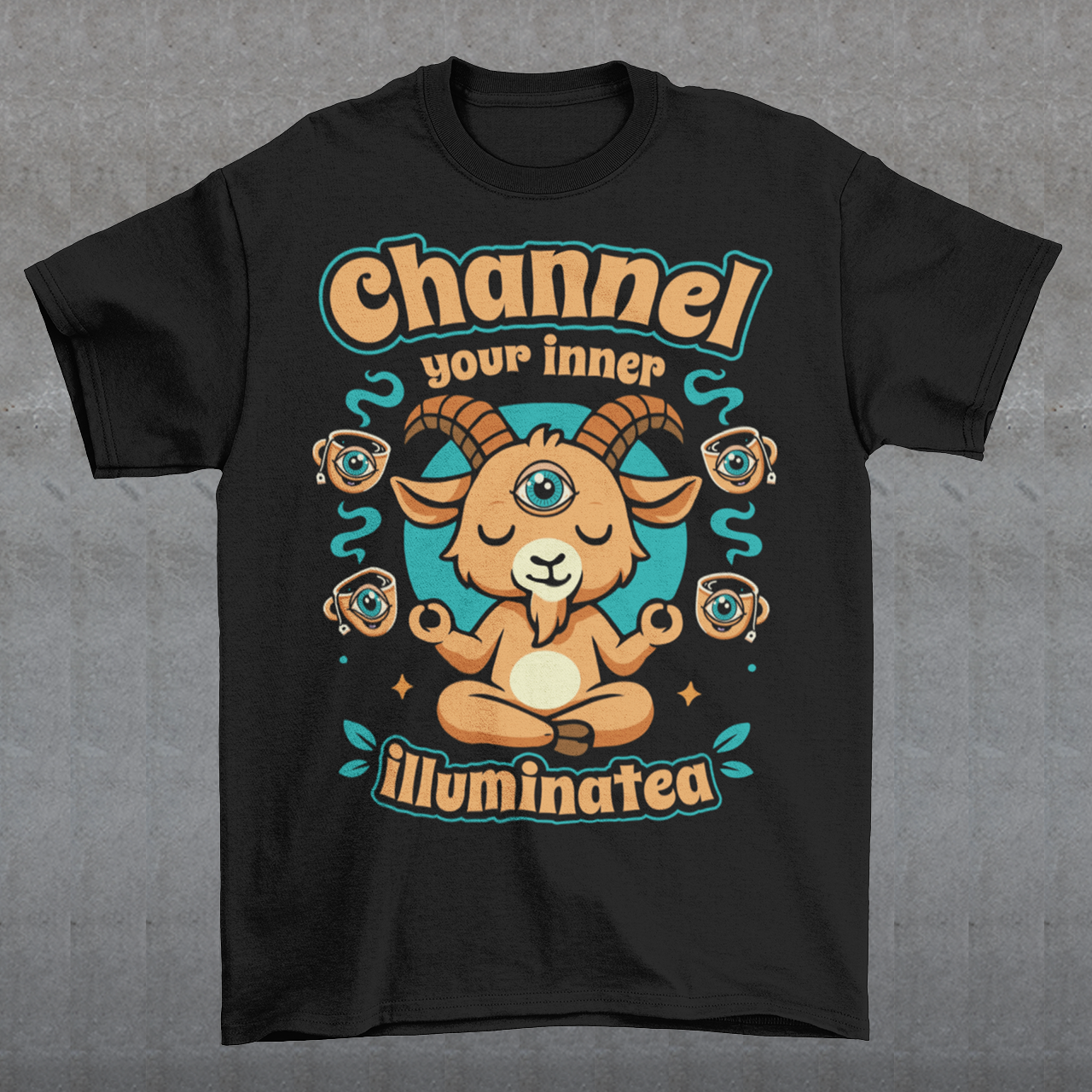 Black t-shirt featuring a humorous occult-inspired design with the text “Channel Your Inner Illuminatea.” The artwork shows a meditating goat with a third eye, crossed legs, and raised hands, surrounded by floating teacups decorated with all-seeing eyes. Teal and tan accents create a mystical aesthetic blending spiritual symbolism, conspiracy humor, meditation themes, and playful occult artwork. Perfect for fans of witchy, esoteric, and funny graphic tees.