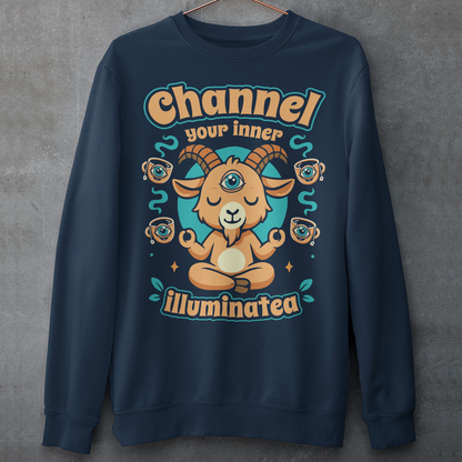 Navy t-shirt featuring a humorous occult-inspired design with the text “Channel Your Inner Illuminatea.” The artwork shows a meditating goat with a third eye, crossed legs, and raised hands, surrounded by floating teacups decorated with all-seeing eyes. Teal and tan accents create a mystical aesthetic blending spiritual symbolism, conspiracy humor, meditation themes, and playful occult artwork. Perfect for fans of witchy, esoteric, and funny graphic tees.