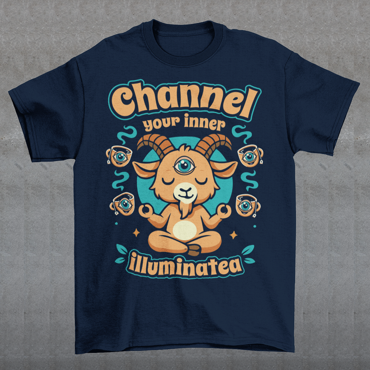 Navy t-shirt featuring a humorous occult-inspired design with the text “Channel Your Inner Illuminatea.” The artwork shows a meditating goat with a third eye, crossed legs, and raised hands, surrounded by floating teacups decorated with all-seeing eyes. Teal and tan accents create a mystical aesthetic blending spiritual symbolism, conspiracy humor, meditation themes, and playful occult artwork. Perfect for fans of witchy, esoteric, and funny graphic tees.