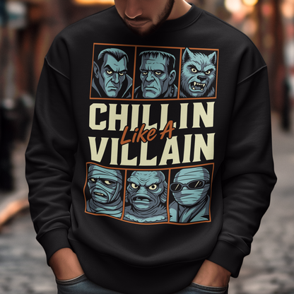 Black sweatshirt featuring the phrase "Chillin Like A Villain" with six classic horror monster portraits, including a vampire, Frankenstein's monster, werewolf, mummy, swamp creature, and the Invisible Man. The retro-inspired graphic uses distressed vintage styling with bold cream and orange lettering, making it a fun horror-themed shirt for Halloween, monster movie fans, goth fashion lovers, and classic horror enthusiasts.