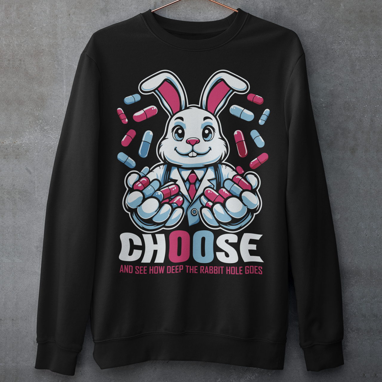 Black sweatshirt of a white rabbit holding blue and red pills with text underneath CHOOSE AND SEE HOW DEEP THE RABBIT HOLE GOES.