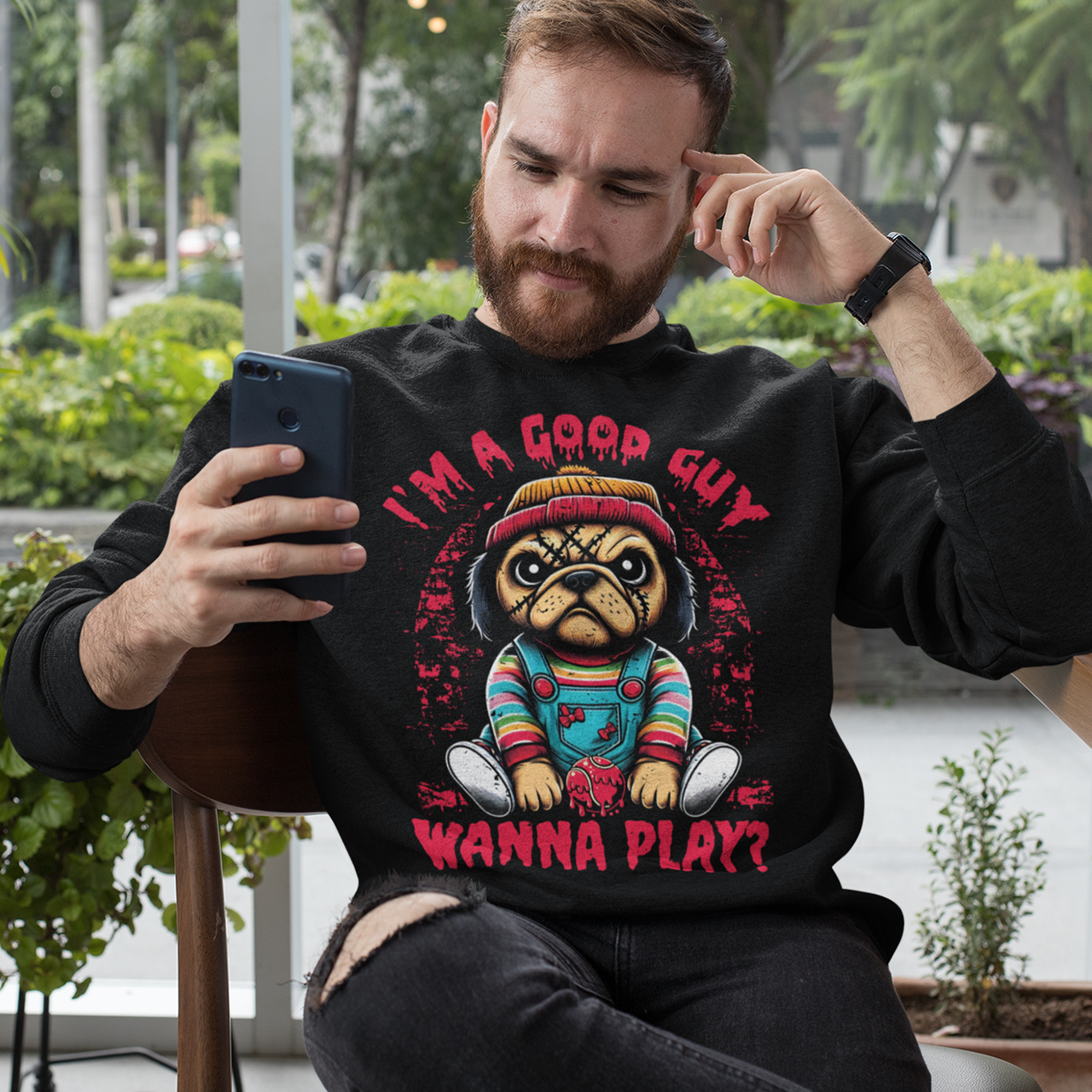 Black sweatshirt of a Chucky Pug with text above "I'M A GOOD GUY". Text below WANNA PLAY?