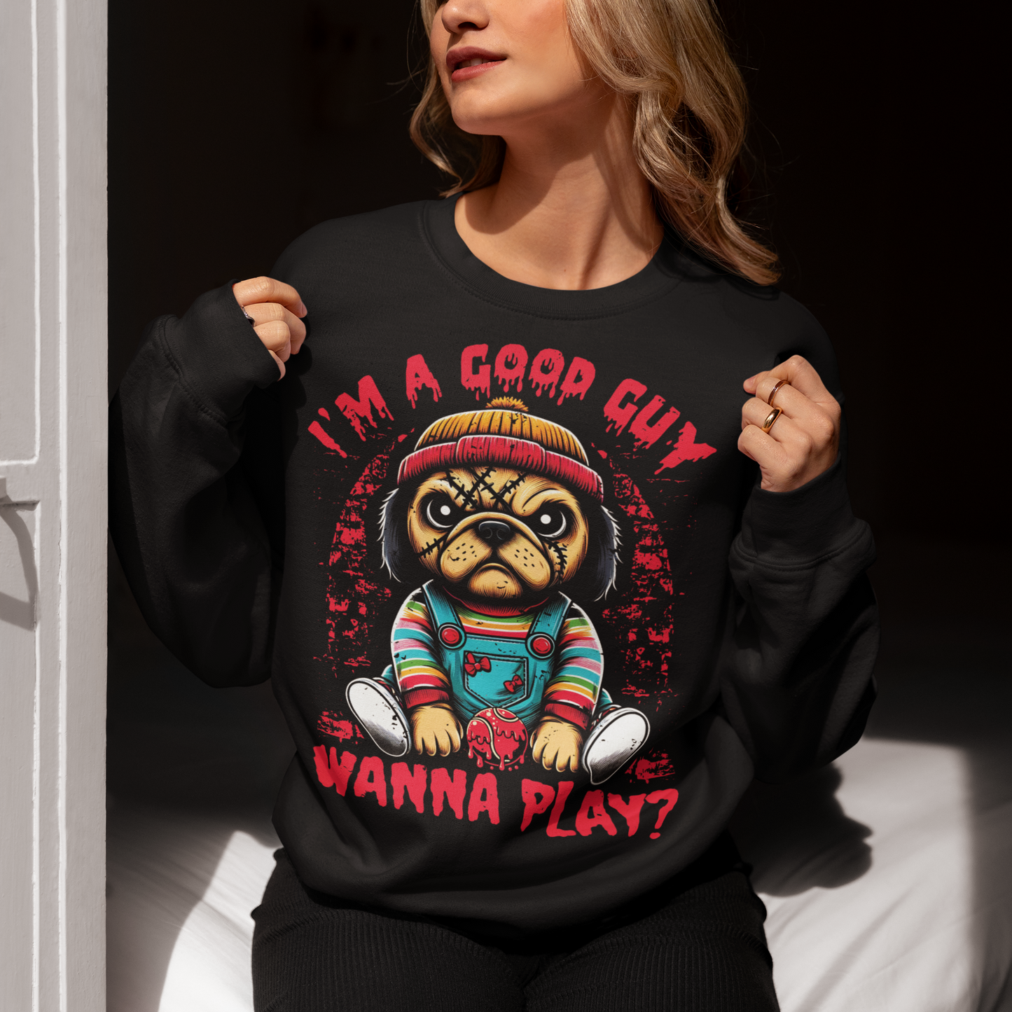 Black sweatshirt of a Chucky Pug with text above "I'M A GOOD GUY". Text below WANNA PLAY?