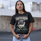 Black t-shirt of a chupacabra sucking on a goat in the desert with text above THE GOAT SUCKER CHUPACABRA ang text below TERROR OF THE DESERT.