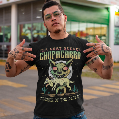 Introducing the ultimate homage to folklore and mystery – "The Goat Sucker Chupacabra" T-shirt! Step into the realm of the unknown with this captivating design depicting the infamous chupacabra in action. Against the backdrop of a barren desert, the chupacabra is depicted in all its eerie glory, locked in its iconic pose of sucking the life force from a hapless goat. Above the striking imagery, bold text proudly proclaims "THE GOAT SUCKER CHUPACABRA" ensuring that the wearer embodies the legend.