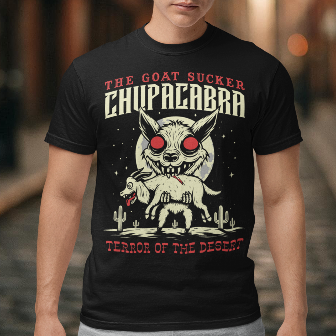 Introducing the ultimate homage to folklore and mystery – "The Goat Sucker Chupacabra" T-shirt! Step into the realm of the unknown with this captivating design depicting the infamous chupacabra in action. Against the backdrop of a barren desert, the chupacabra is depicted in all its eerie glory, locked in its iconic pose of sucking the life force from a hapless goat. Above the striking imagery, bold text proudly proclaims "THE GOAT SUCKER CHUPACABRA" ensuring that the wearer embodies the legend.