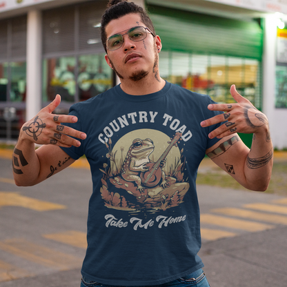 Introducing our delightful "Country Toad Take Me Home" t-shirt, where whimsy and charm come together in perfect harmony. This enchanting design captures the essence of a peaceful evening in the countryside, transporting you to a world where nature and music blend seamlessly. At the center of the design, you'll find a vibrant depiction of a serene pond illuminated by the gentle glow of the moon. Resting on a moss-covered rock, a plucky frog musician steals the show as it strums a banjo.