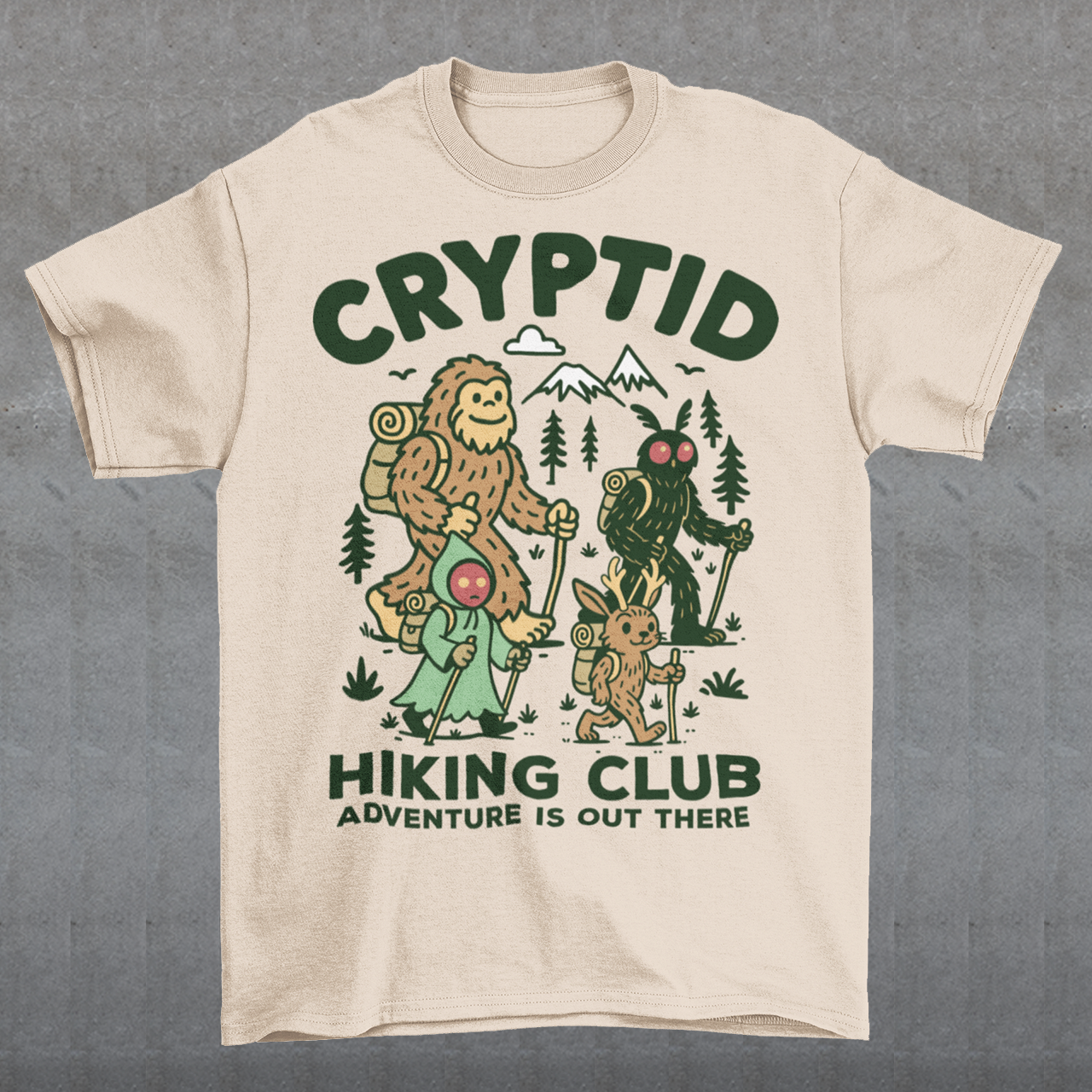 Beige t-shirt featuring a playful “Cryptid Hiking Club” design with Bigfoot, Mothman, flatwoods monster, and a jackalope hiking together through a forest trail. The artwork includes mountains, pine trees, backpacks, and trekking poles with the slogan “Adventure Is Out There.” A fun outdoor-themed graphic perfect for cryptid fans, hikers, campers, paranormal enthusiasts, and lovers of folklore-inspired apparel.
