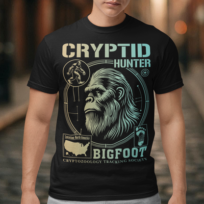Illustration of a cryptozoology-themed t-shirt featuring a stylized image of Bigfoot's head, shown with shaggy fur, deep-set eyes, and a mysterious expression. The artwork has a bold, rugged design in earthy tones, emphasizing the mythical nature of the creature. Above the image, the words "CRYPTID HUNTER" are prominently displayed in large, distressed lettering, suggesting adventure and mystery. The design appeals to fans of folklore, legends, and unexplained phenomena.