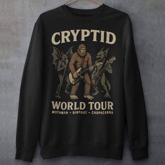 Rock out with legends from beyond the myths! This bold graphic sweatshirt features Mothman, Bigfoot, and the Chupacabra shredding as a rock band, headlining the CRYPTID WORLD TOUR. With vintage concert-poster vibes, it’s the perfect blend of spooky lore and rock ’n’ roll energy.
